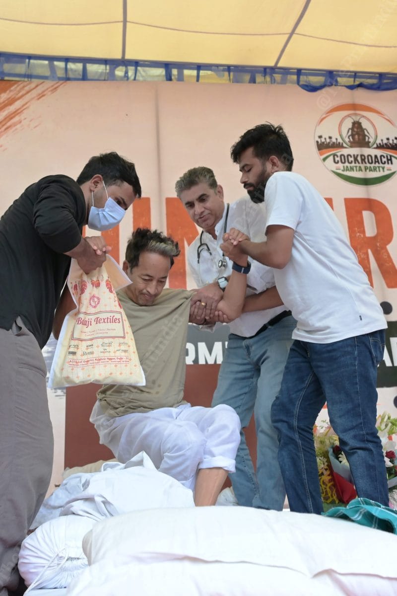 Activist Sonam Wangchuk is helped up by Cockroach Janta Party founder Abhijeet Dipke and others during his hunger strike at Jantar Mantar in New Delhi | Photo: Suraj Singh Bisht | ThePrint