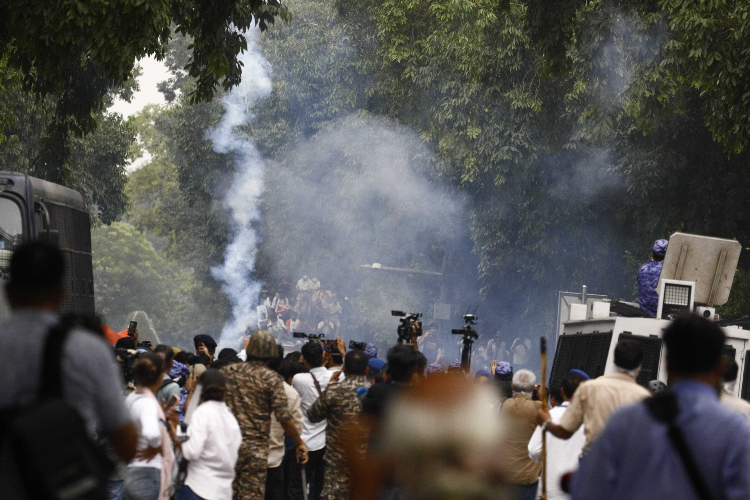 Smoke rises as security forces make use of tear gas cannons in attempts to disperse protesters marching towards Parliament Monday. | Praveen Jain/ThePrint