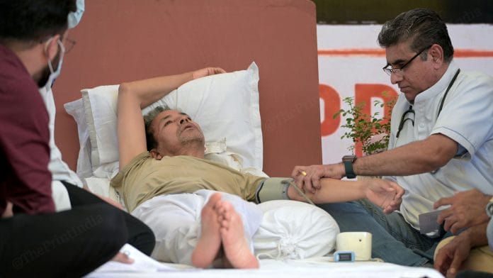 A doctor checks Sonam Wangchuk’s blood pressure and monitors his health closely during his ongoing hunger strike at Jantar Mantar | Photo: Suraj Singh Bisht | ThePrint