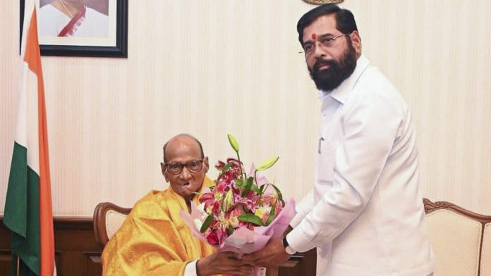 In this image posted on July 8, 2026, Maharashtra Deputy Chief Minister Eknath Shinde felicitates NCP (SP) President Sharad Pawar during a meeting, in Mumbai. | PTI