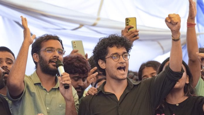 Cockroach Janta Party (CJP) Spokespersons Saurav Das and Ashutosh Ranka, with supporters, celebrate after Union Education Minister Dharmendra Pradhan resigned and took responsibility for the NEET paper leak, at Jantar Mantar in New Delhi, Saturday, July 25, 2026 | PTI