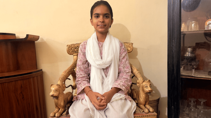 Tejaswi sitting on a gold-painted chair, decorated in their drawing room which was once be used by the rulers of Kherwagarh | Saman Husain | ThePrint