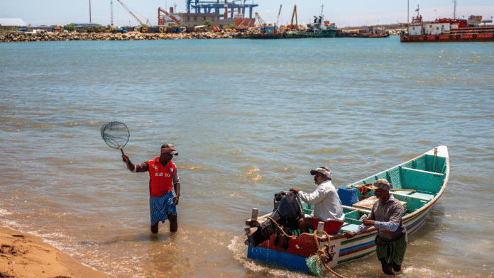 Fishermen arrive at the Vizhinjam village adjacent to the Vizhinjam transshipment container port, developed by Adani Ports and Special Economic Zone Ltd.|Bloomberg