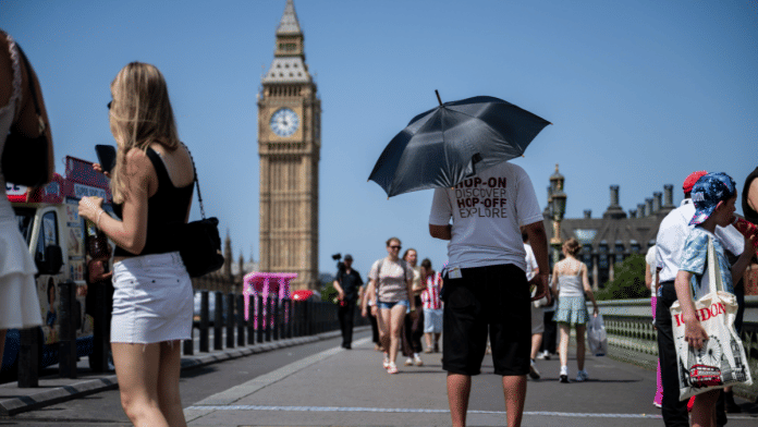 A tour bus worker shelters from the sun in central London. | Chris J. Ratcliffe/Bloomberg