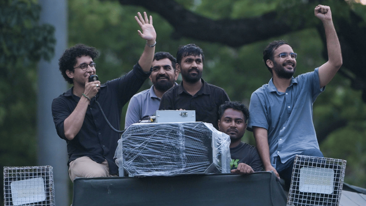 CJP spokesperson Deepak Baliyan (centre) soaks in the festivity with his colleagues Saurav Das and Ashutosh Ranka after the resignation of the education minister, in Jantar Mantar | Suraj Singh Bisht | ThePrint