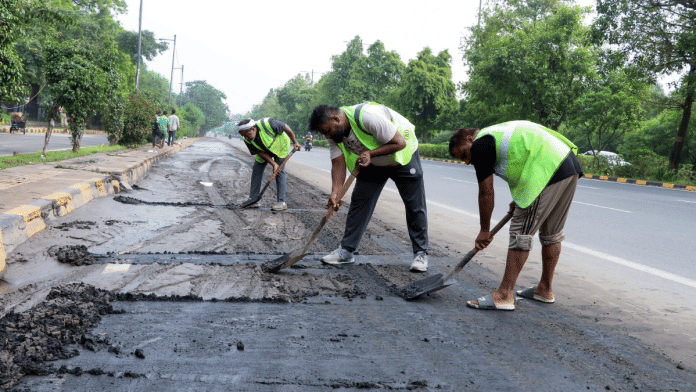 File photo of civic workers at work on a road | ANI