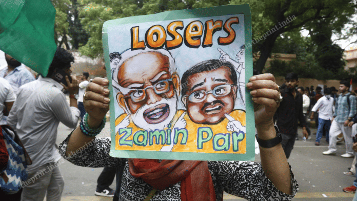 Poster lampooning Prime Minister Narendra Modi and Education Minister Dharmendra Pradhan at Jantar Mantar on Saturday | Praveen Jain | ThePrint