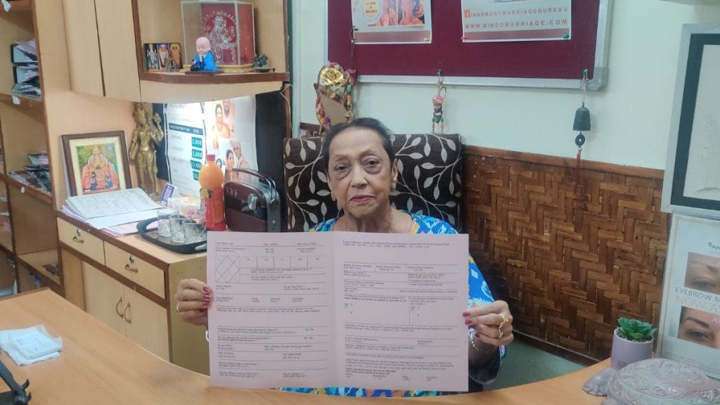 Nandini Suresh Dange, 82, holds up a form for brides at the Harmony Marriage Bureau. Stela Dey | ThePrint