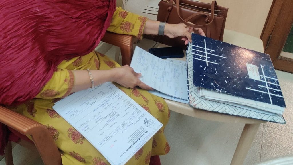 A woman fills up a form for her son at the Harmony Marriage Bureau. Stela Dey | ThePrint