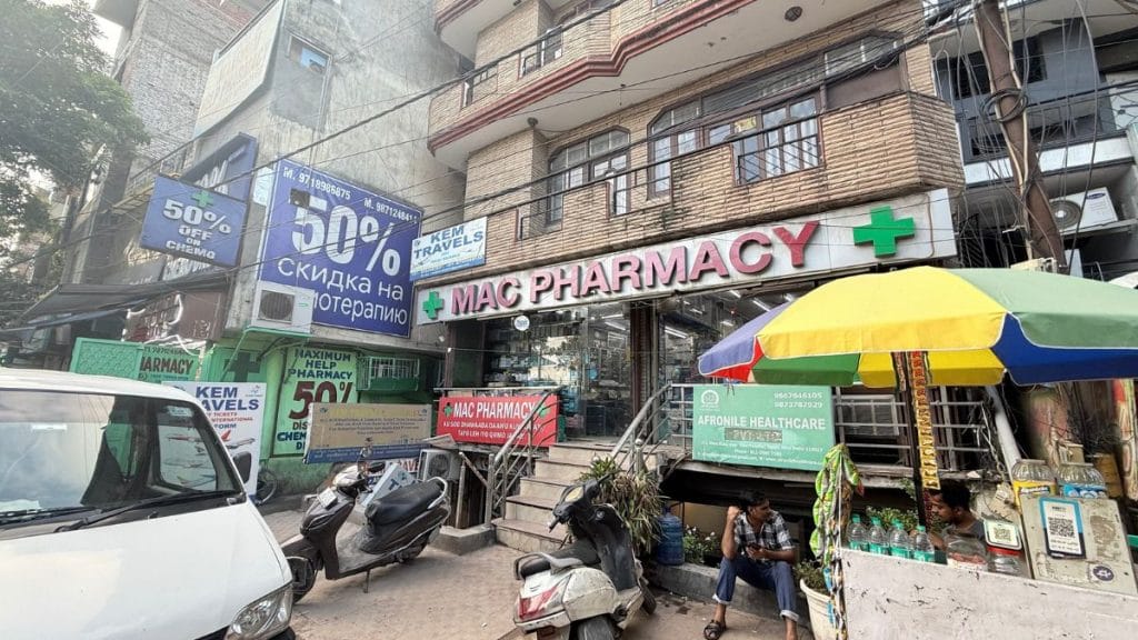 Most pharmacies opposite Max have signs in foreign languages, this one advertises chemotherapy drugs at a 50% discount in Cyrilic, right next to the Afronile Healthcare medical tourism company. Tarini Unnikrishnan | ThePrint