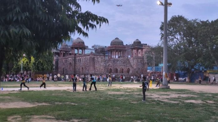 Children play a Mehrauli Premier League match in the shadow of Jahaz Mahal, as residents gather to watch one of Delhi's most distinctive community cricket tournaments | Photo: Himanshi Aggarwal/ThePrint