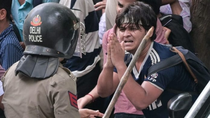 A protester pleads as Delhi Police carry out lathicharge during the CJP march to Parliament | Praveen Jain | ThePrint