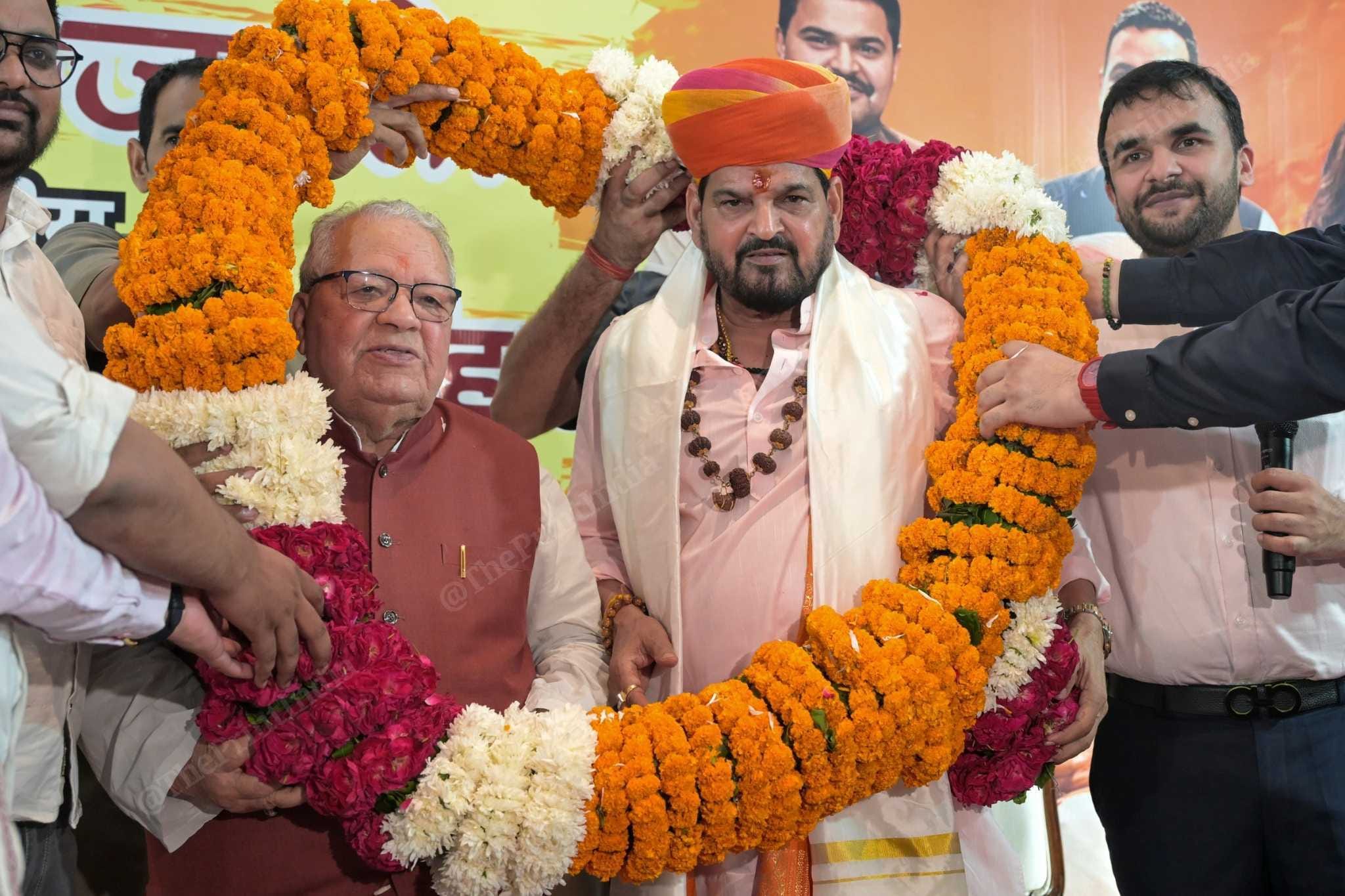 Former WFI chief Brij Bhushan Sharan Singh being garlanded by his supporters at a community hall in Noida, Uttar Pradesh | Photo: Suraj Singh Bisht | ThePrint
