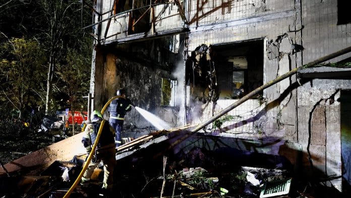 Firefighters work at the site of an apartment building hit by a Russian missile strike on Ukraine, in Kyiv | Gleb Garanich/Reuters