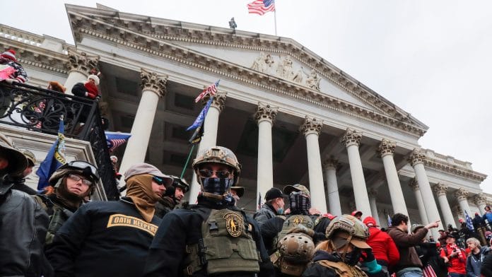 FILE PHOTO: Members of the Oath Keepers militia group stand among supporters of U.S. President Donald Trump occupying the east front steps of the U.S. Capitol in Washington, U.S | REUTERS/Jim Bourg