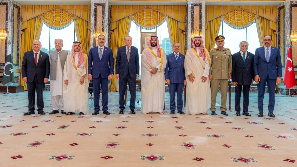 Turkish President Tayyip Erdogan, Saudi Crown Prince Mohammed bin Salman, and Pakistan's Prime Minister Shehbaz Sharif, accompanied by their ministers of Foreign Affairs and Defence, pose after signing a joint defence agreement in Mecca, Saudi Arabia, August 7, 2026. | REUTERS