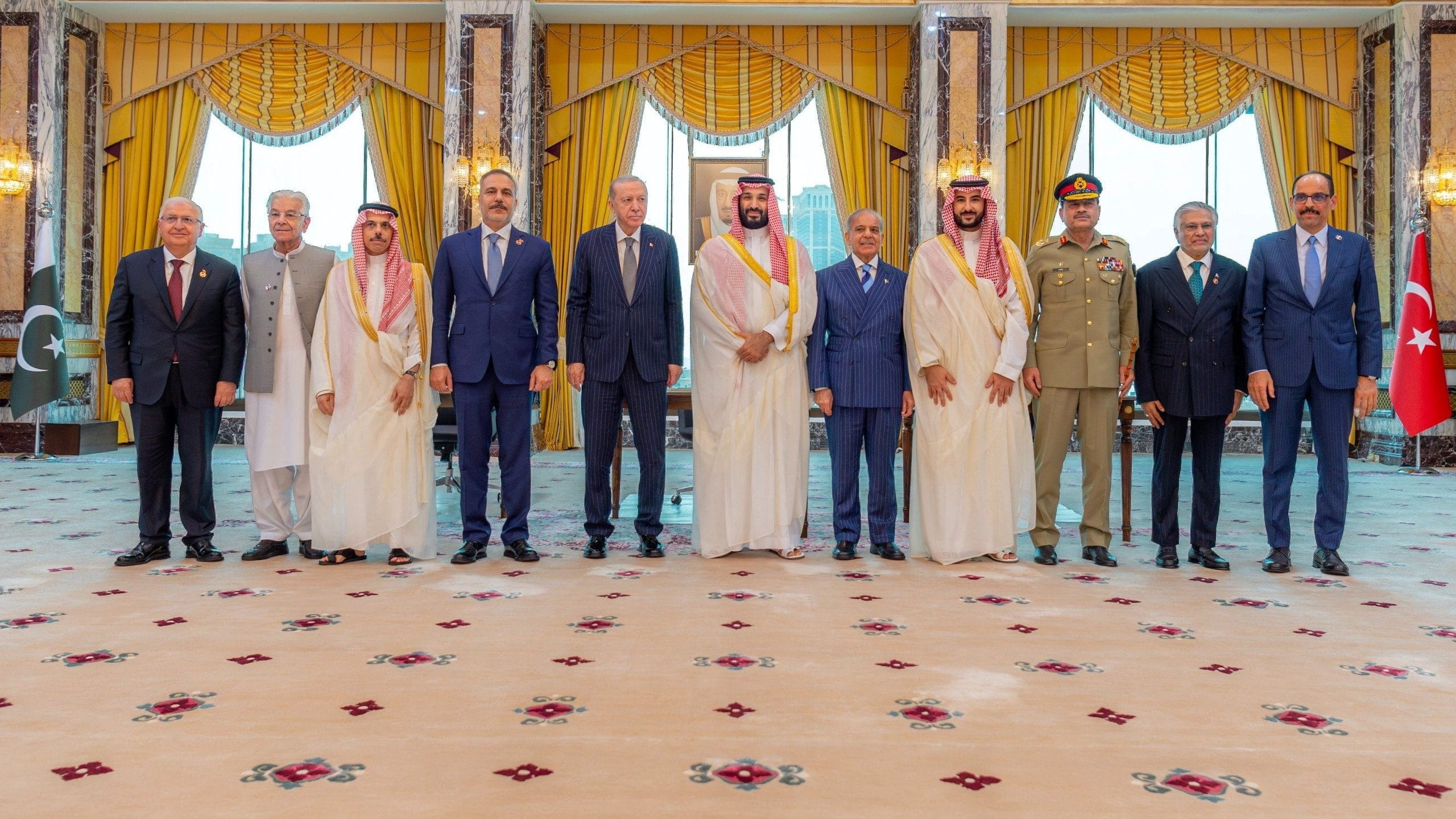 Turkish President Tayyip Erdogan, Saudi Crown Prince Mohammed bin Salman, and Pakistan's Prime Minister Shehbaz Sharif, accompanied by their ministers of Foreign Affairs and Defence, pose after signing a joint defence agreement in Mecca, Saudi Arabia, August 7, 2026. | REUTERS