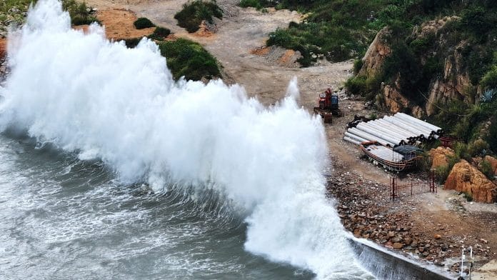 A drone view shows huge waves crashing on the coast of Huangqi, as Typhoon Dolphin approaches, in Huangqi town of Lianjiang, Fuzhou, Fujian province, China | cnsphoto via REUTERS
