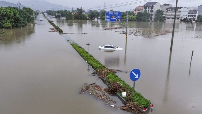 A drone view shows roads and village houses partially submerged in floodwaters, following heavy rainfall brought by Typhoon Dolphin, in Yantou town, Yongjia county, Wenzhou, Zhejiang province, China August 10, 2026. | REUTERS