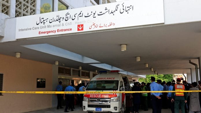 Police officers move past an ambulance outside an intensive care unit after a fire broke out at the Pakistan Institute of Medical Sciences (PIMS) hospital in Islamabad, Pakistan, August 26, 2026. REUTERS/Akhtar Soomro