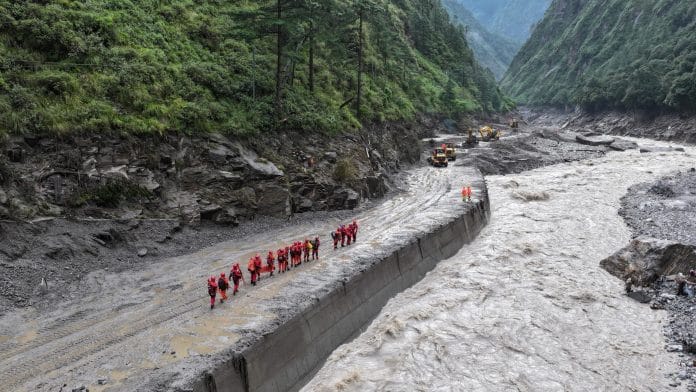 A drone view of firefighters conducting search and rescue operations at a damaged road leading to Gyirong Port after a mudslide, in Gyirong county, Shigatse, Tibet Autonomous Region, China August 28, 2026. | cnsphoto via REUTERS