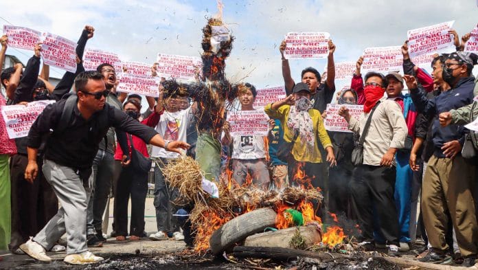 Protesters burn effigies during the 48-hour general strike called by the Campaign for Just and Fair Delimitation (JFD), demanding the National Register of Citizens (NRC) updation before the Census 2027, in Imphal | ANI