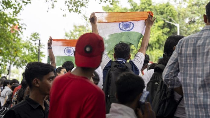 Supporters of the Cockroach Janta Party celebrate after the government accepted their key demands, in Mumbai | Bloomberg