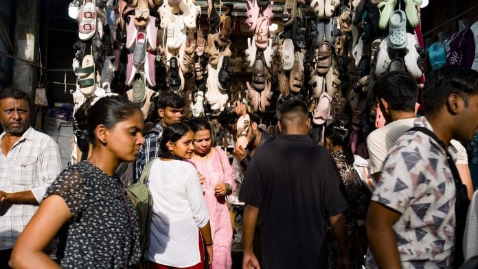 Shoppers pass a shoe stall in Mumbai. | Abeer Khan/Bloomberg