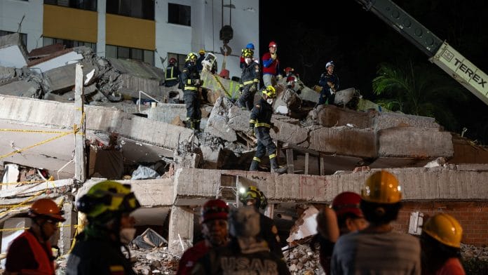 Rescue workers remove rubble from the Cantabria building following the earthquake in Cali, Colombia, on Thursday, Aug. 13, 2026. Colombia turned down a Mexican rescue team that sought to assist with earthquake rescue efforts, raising questions about the governments management of the disaster as the death toll mounted and an aftershock prompted fresh evacuations. | Bloomberg