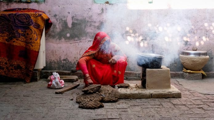 Smoke bellows from a domestic hearth known as a 'chulha' using dung cakes, made from the by-products of animal husbandry, as cooking fuel at a village in Greater Noida, Uttar Pradesh, India, on Monday, Feb. 22, 2021. Provisions for LPG cooking fuel subsidies, launched in 2016 by the Modi government offering cash rebates for purchasing an LPG connection and a loan for the first canister of the fuel and stove, were halved in the federal budget for the fiscal year ending March 2022 to 124.8 billion rupees ($1.7 billion) from 255 billion rupees a year earlier. | Bloomberg