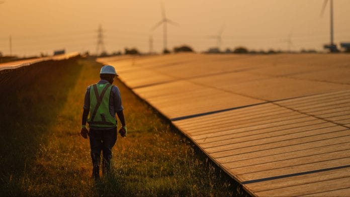 A maintenance worker inspects solar panels in Tuticorin, India. | Photographer: Prashanth Vishwanathan/Bloomberg