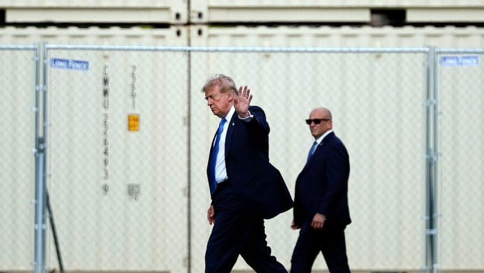 President Donald Trump waves after stepping off Marine One after landing at the Ellipse near the White House on August 28. | Bloomberg