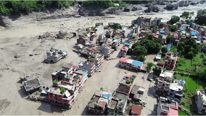 An aerial view of houses partially submerged in mud-laden flash flood following an outburst in the Bhotekoshi River in Rasuwa, Nepal Wednesday | ANI Video Grab