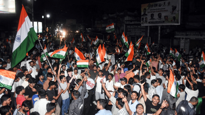 JPSC-JSSC aspirants wave the national flag as they celebrate after the Jharkhand government accepted their demands and cancelled the JSSC-CGL exam and all exams conducted on behalf of TDPL, in Ranchi on Monday | ANI