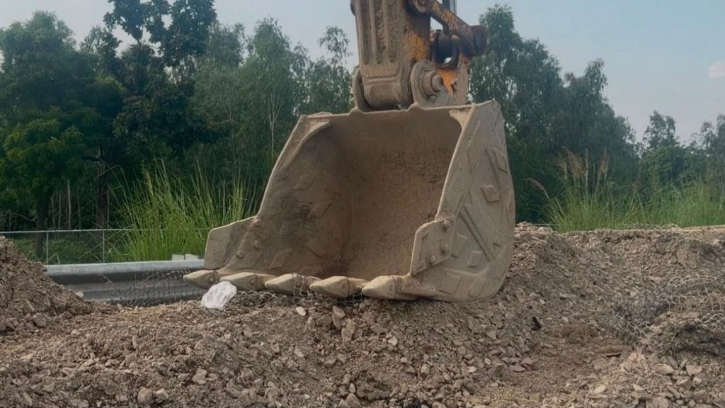 Old construction mesh, pulled out during repairs on the Kanpur-Lucknow expressway, lies tangled beneath the bucket of an excavator. Saman Husain | ThePrint