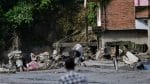 A man carrying his belongings moves through debris following devastating floods, in Trishuli in Nuwakot district, Nepal, on 27 August, 2026 | Navesh Chitrakar/Reuters