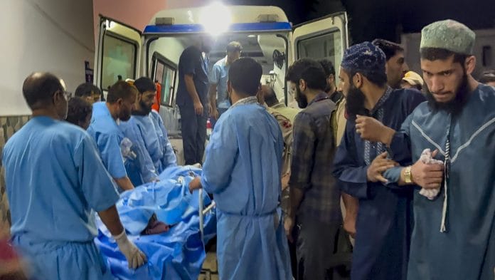Medical personnel shift an injured migrant worker to an ambulance outside the Government Medical College (GMC) Hospital after terrorists opened fire on two non-local labourers at a brick kiln in the Kellam area of Kulgam district, in Anantnag, Jammu and Kashmir | PTI