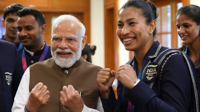 Prime Minister Narendra Modi shares a light moment with boxer Lovlina Borgohain during a felicitation ceremony for India's Glasgow 2026 Commonwealth Games contingent at his residence, in New Delhi. | PTI