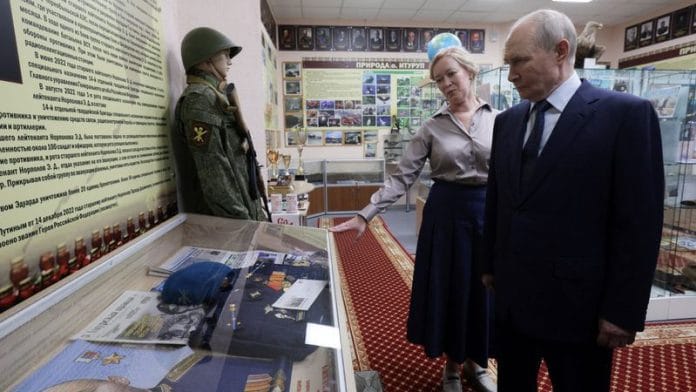 Russian President Vladimir Putin, accompanied by Sakhalin region Minister of Education Anastasia Kikteva, tours a museum of a local school during his visit on the Southern Kuril Island of Iturup, in far eastern Sakhalin Region, Russia, August 13, 2026. Sputnik/Gavriil Grigorov/Pool via REUTERS