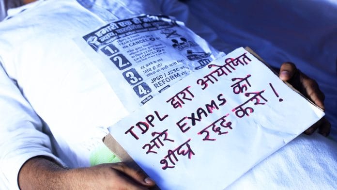 A protester holding a placard at Jaipal Singh Munda Stadium in Ranchi on 6 August, 2026 | Anisha Nehra/ThePrint