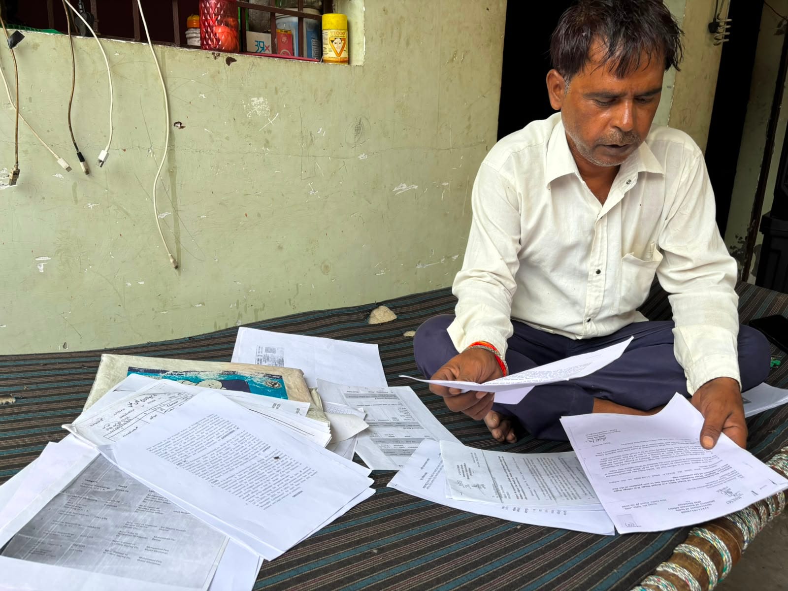 Badal’s father Kripal Singh looking for documents. | Samridhi Tewari