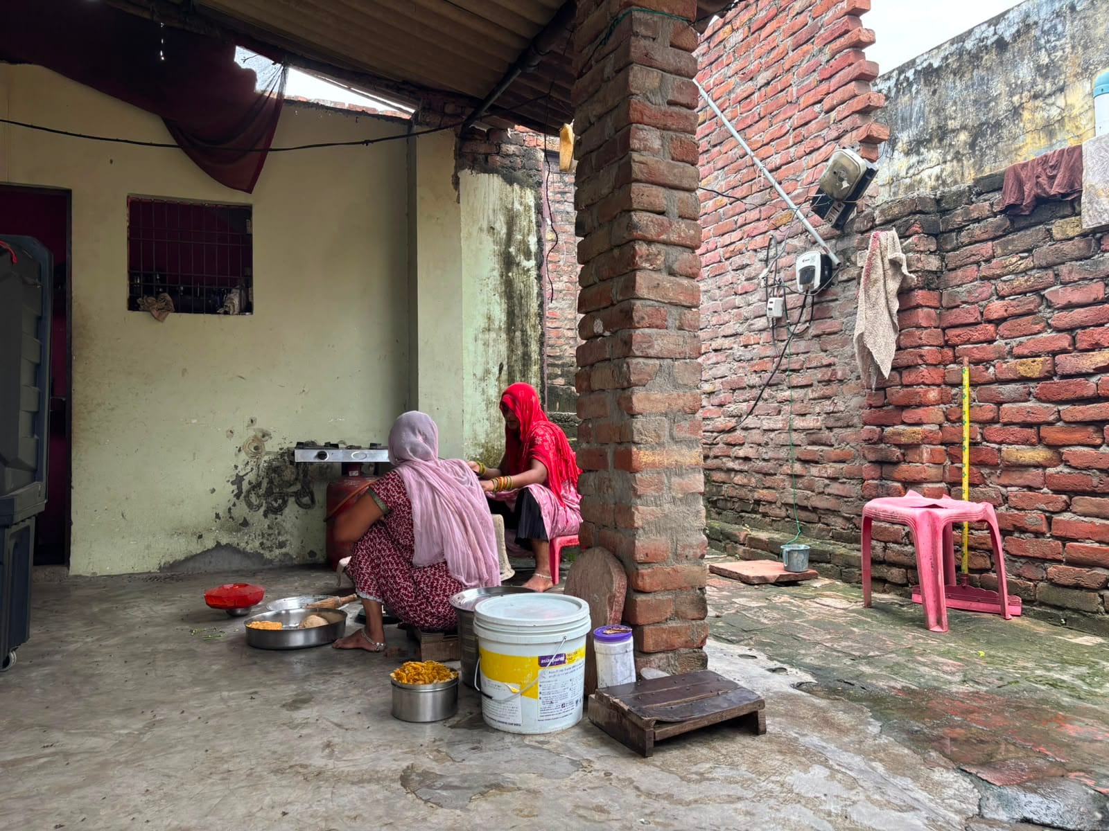 Badal Babu’s mother and sister-in-law making food at their village home in Aligarh. | Samridhi Tewari