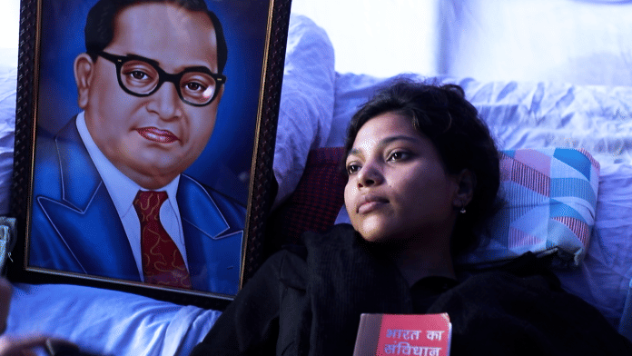 One of the protestors, Umme Habiba, who is on a hunger strike, clutches a copy of the Constitution. | Anisha Nehra | ThePrint