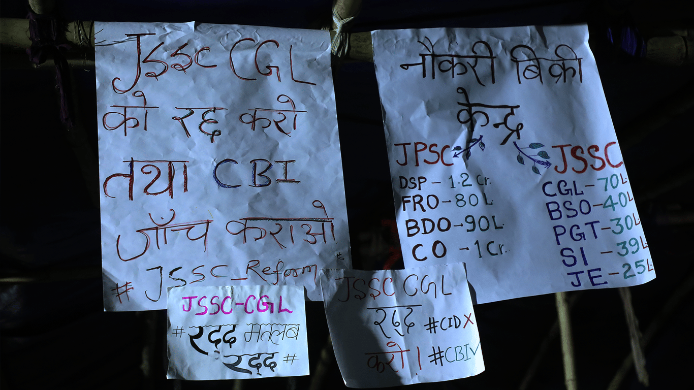 Protesters hold placards demanding a CBI inquiry into the alleged JSSC-CGL recruitment scam and reforms in the JSSC recruitment process during a demonstration in Jharkhand. | Anisha Nehra | ThePrint
