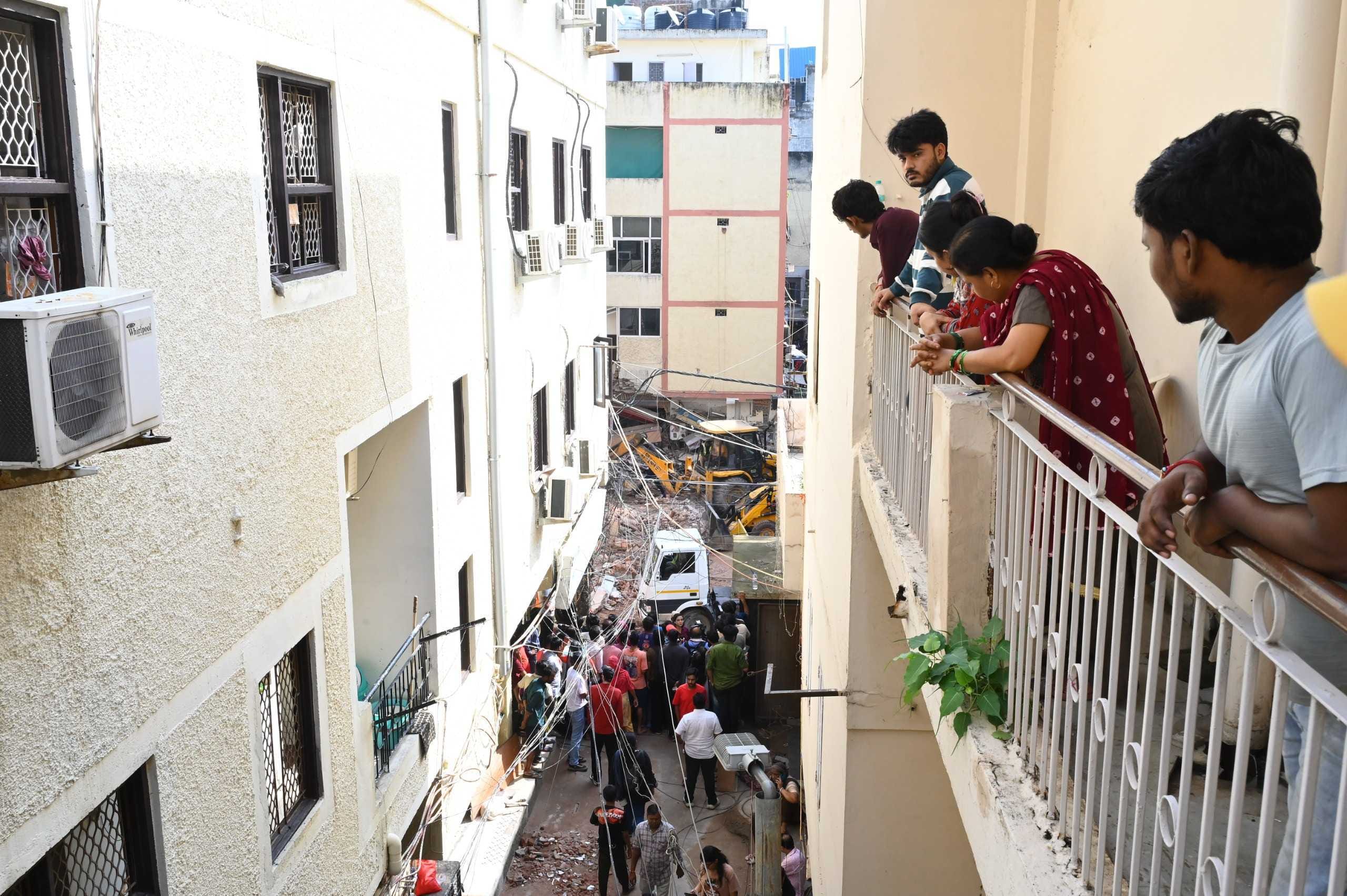 Delhi Fire Service and NDRF personnel conduct rescue operations at the site of a building collapse in Satya Niketan on Monday. ThePrint Photos.