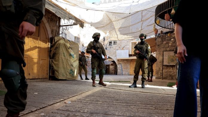 Israeli soldiers keep watch during Israeli settlers' weekly tour in Hebron, in the Israeli-occupied West Bank, September 5, 2026. | Mussa Qawasma/Reuters