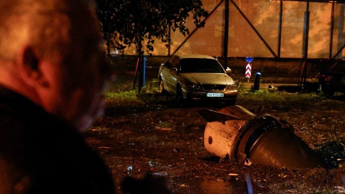 A resident looks at a part of a Russian ballistic missile that got stuck in the ground after a strike, amid Russia's attack on Ukraine, in Kyiv, Ukraine September 24, 2026. REUTERS/Valentyn Ogirenko
