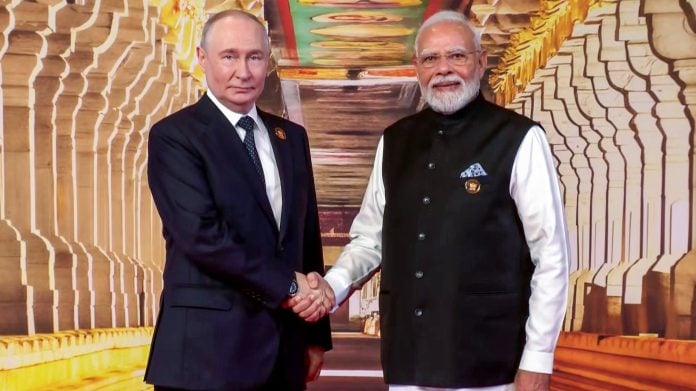 Prime Minister Narendra Modi and Russian President Vladimir ‌Putin exchange a handshake at Bharat Mandapam ahead of the 18th BRICS Leaders’ Summit 2026, in New Delhi on Saturday. (DD News/ANI Video Grab)