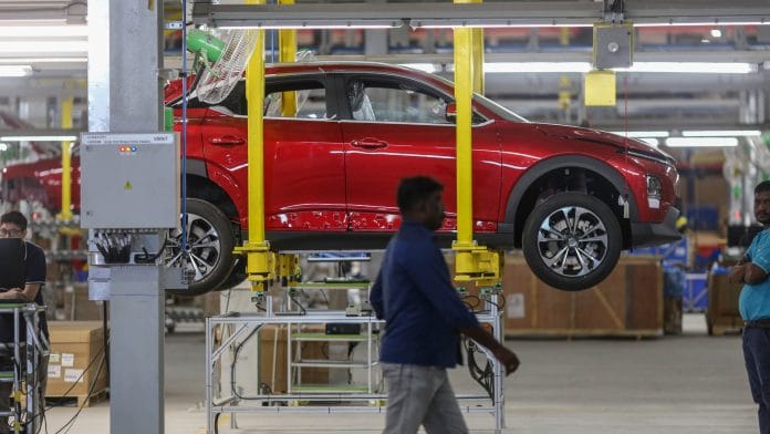 An electric vehicle assembly line in India. | Bloomberg