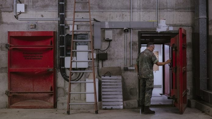 A soldier opens the entrance doors to the bunker at the Bundeswehr Hospital in Ulm. | Jana Islinger/Bloomberg